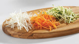 Wooden Board with julienne sliced zucchini, carrot and potato  